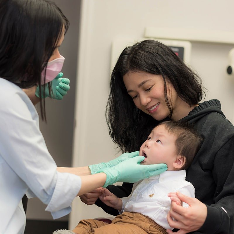 Calgary woman and baby getting thorough checkup from Calgary Dentist Dr. My Le